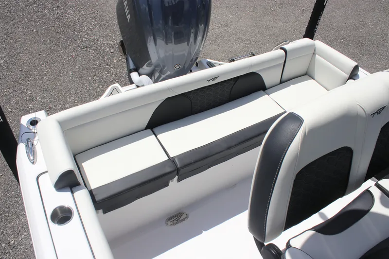 Slide: The Image of 2026 Tidewater 232 LXF boat interior with cushioned seating and Yamaha engine. - 12