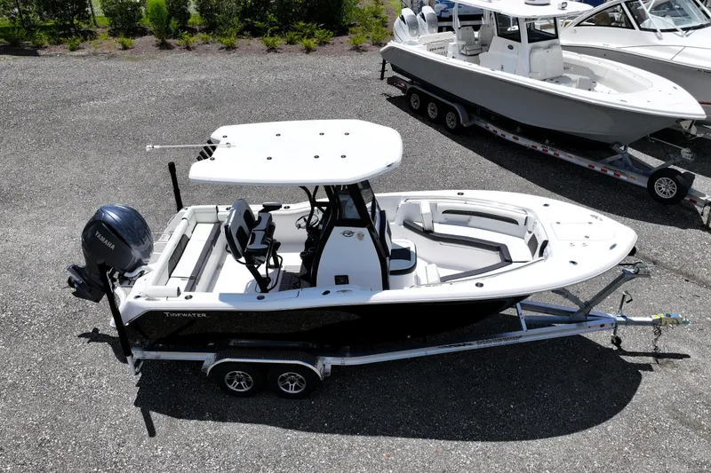 Slide: The Image of 2026 Tidewater 232 LXF boat on trailer, featuring Yamaha engine, parked outdoors. - 2