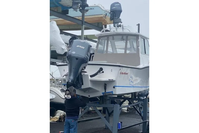 The Image of 2021 NorthCoast 235 Cabin boat on stand, with Yamaha 250 outboard motor. - 0