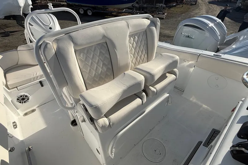 Slide: The Image of 2026 Sea Hunt Ultra 255 SE boat interior with white cushioned seating and Yamaha engines. - 11