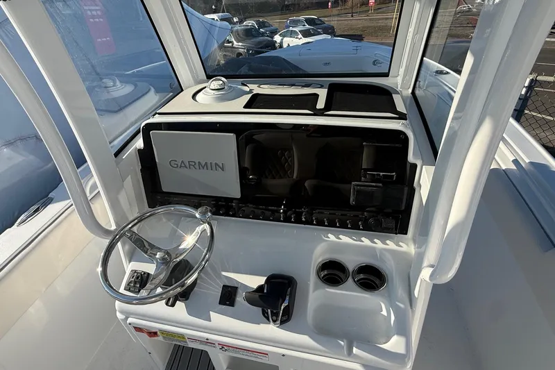 Slide: The Image of 2026 Sea Hunt Ultra 255 SE boat dashboard with Garmin navigation system and steering wheel. - 12