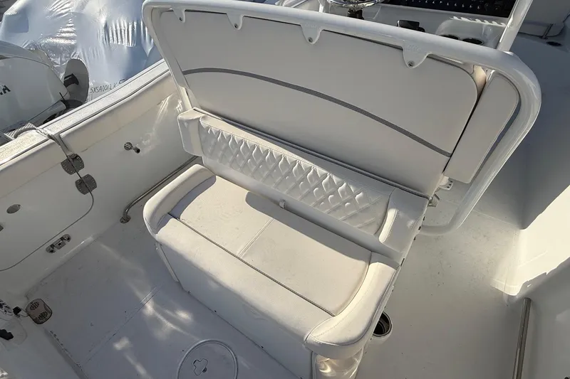 Slide: The Image of 2026 Sea Hunt Ultra 255 SE boat interior with cushioned seating and storage. - 14