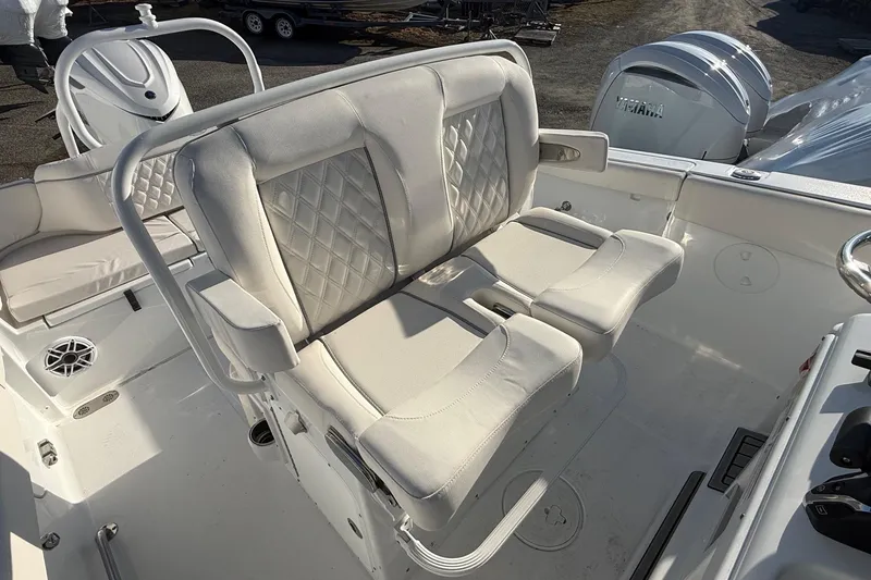 Slide: The Image of 2026 Sea Hunt Ultra 255 SE boat interior with cushioned seating and steering console. - 15