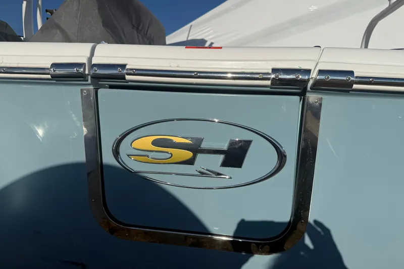 Slide: The Image of 2026 Sea Hunt Ultra 255 SE boat logo on light blue hull. - 16