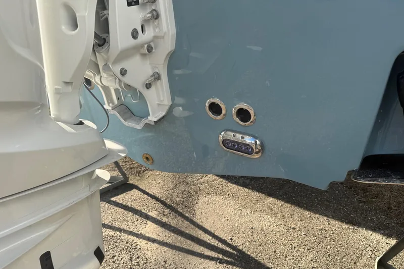 Slide: The Image of 2026 Sea Hunt Ultra 255 SE boat stern with motor and underwater lights. - 17