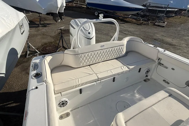 Slide: The Image of 2026 Sea Hunt Ultra 255 SE boat interior with cushioned seating and storage compartments. - 2