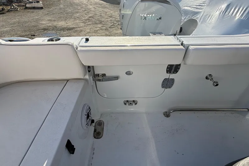 Slide: The Image of Interior view of 2026 Sea Hunt Ultra 255 SE boat, featuring seating and Yamaha engine. - 7