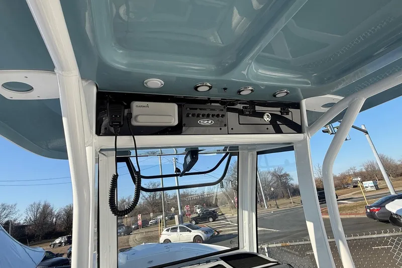 Slide: The Image of 2026 Sea Hunt Ultra 255 SE boat console with Garmin electronics and overhead storage. - 8