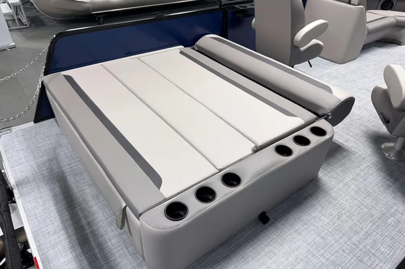 Slide: The Image of 2026 Premier 200 Sunscape RL Tritoon interior with gray seating and cup holders. - 12