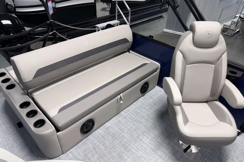Slide: The Image of Premier 200 Sunscape RL Tritoon 2026 interior with luxurious seating and cup holders. - 13