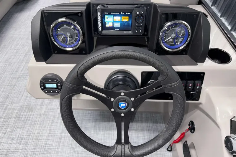 Slide: The Image of 2026 Premier 200 Sunscape RL Tritoon dashboard with steering wheel and navigation controls. - 16