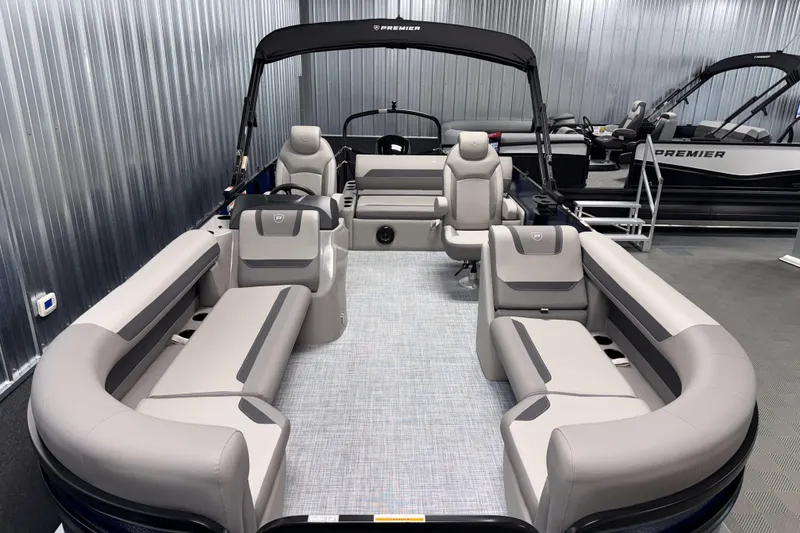 Slide: The Image of 2026 Premier 200 Sunscape RL Tritoon with luxurious seating in a showroom setting. - 8