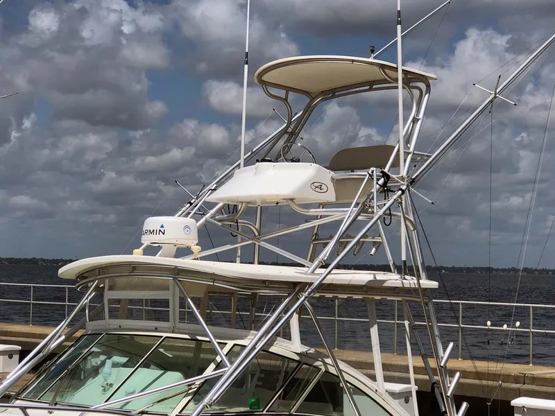 Slide: The Image of 2005 Albemarle 310 Sport Fisherman boat with tower and Garmin equipment, docked under cloudy skies. - 12
