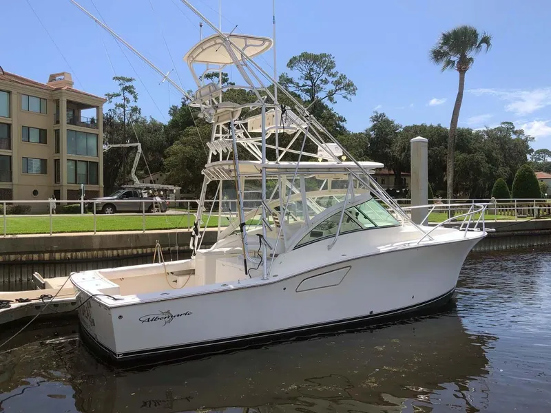 Slide: The Image of 2005 Albemarle 310 Sport Fisherman boat docked by waterfront homes. - 3
