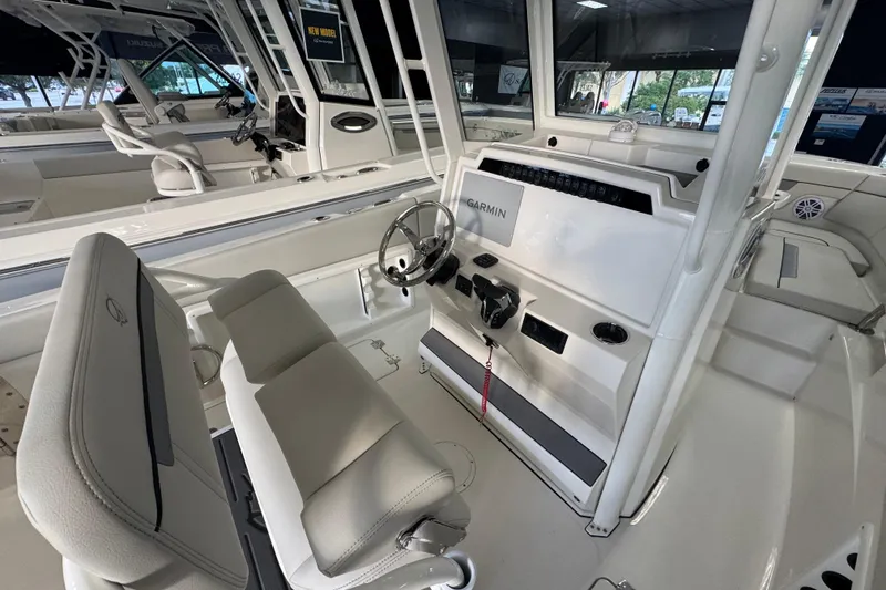 Slide: The Image of 2026 Sailfish 252 CC boat interior with Garmin navigation system and modern helm design. - 11