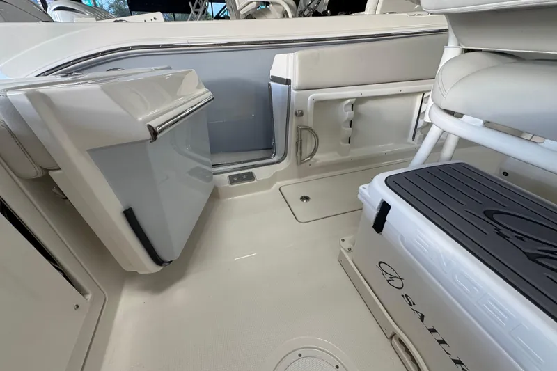 Slide: The Image of 2026 Sailfish 252 CC boat interior with open storage compartments and seating. - 12