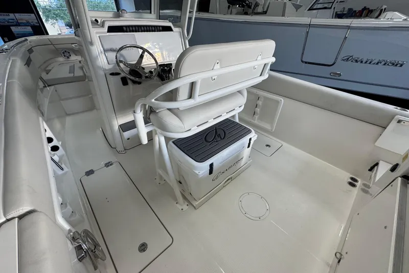 Slide: The Image of 2026 Sailfish 252 CC boat interior with steering console and seating area. - 13