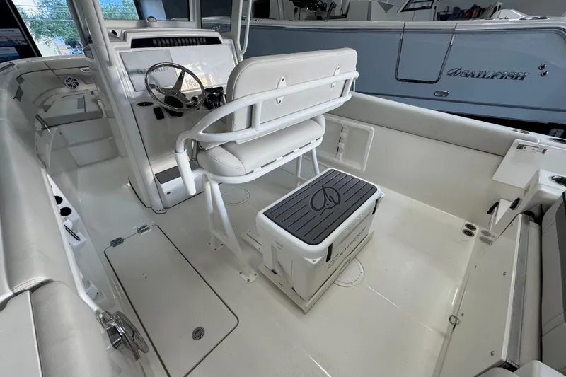 Slide: The Image of Interior of 2026 Sailfish 252 CC boat, featuring helm and seating area. - 16