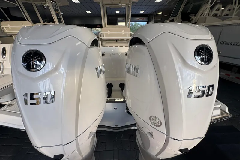 Slide: The Image of Twin Yamaha 150 engines on a 2026 Sailfish 252 CC boat in showroom. - 18