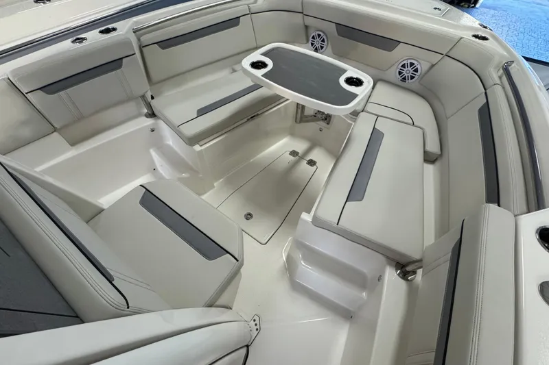 Slide: The Image of 2026 Sailfish 252 CC boat interior with cushioned seating and table. - 8