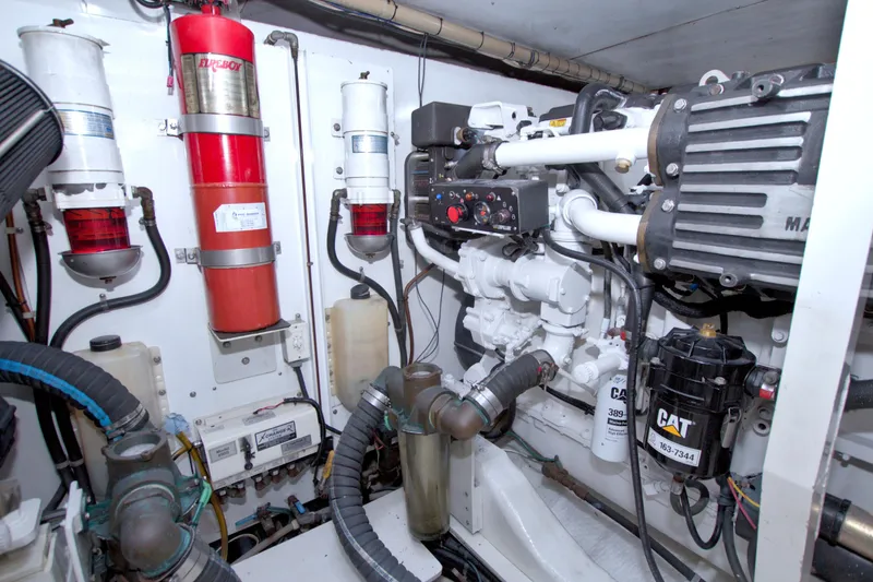 Slide: The Image of Engine room of 2005 Neptunus 62 Flybridge yacht with CAT components and fire extinguisher. - 100