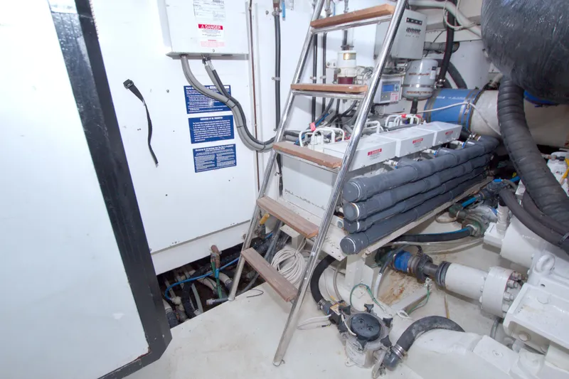 Slide: The Image of Engine room of 2005 Neptunus 62 Flybridge yacht with equipment and ladder. - 109
