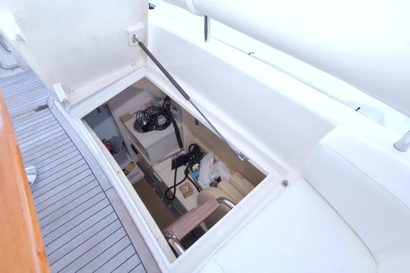 Slide: The Image of Storage compartment on 2005 Neptunus 62 Flybridge yacht, featuring organized cables and equipment. - 120