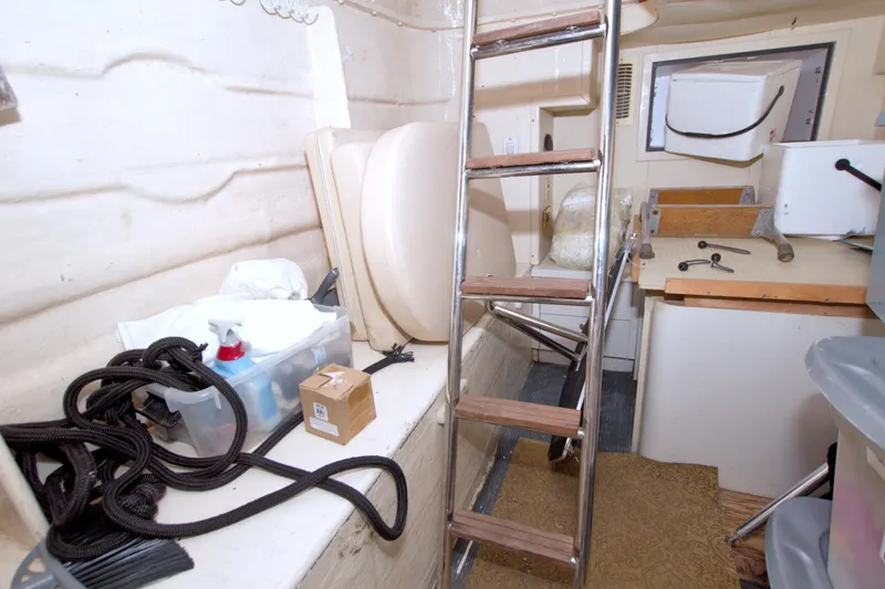 Slide: The Image of 2005 Neptunus 62 Flybridge interior with ladder, storage, and maintenance tools. - 121