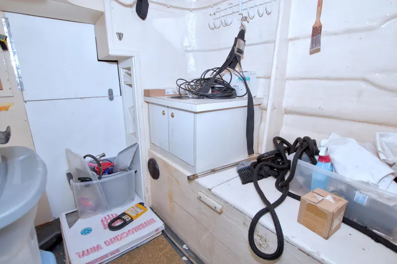 Slide: The Image of Storage area on a 2005 Neptunus 62 Flybridge yacht with various equipment and supplies. - 124