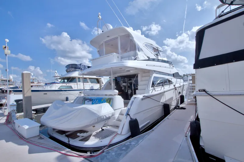 Slide: The Image of 2005 Neptunus 62 Flybridge yacht docked under a clear blue sky. - 125