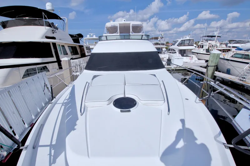 Slide: The Image of 2005 Neptunus 62 Flybridge yacht docked at marina under blue sky. - 13