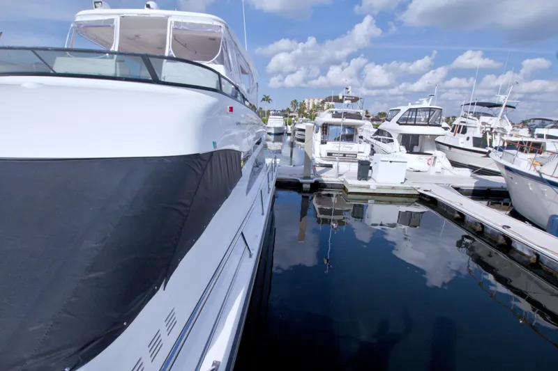 Slide: The Image of 2005 Neptunus 62 Flybridge yacht docked at marina under blue sky. - 15