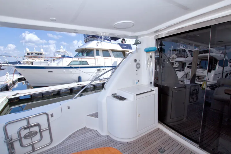 Slide: The Image of 2005 Neptunus 62 Flybridge yacht interior with marina view and sleek design. - 18