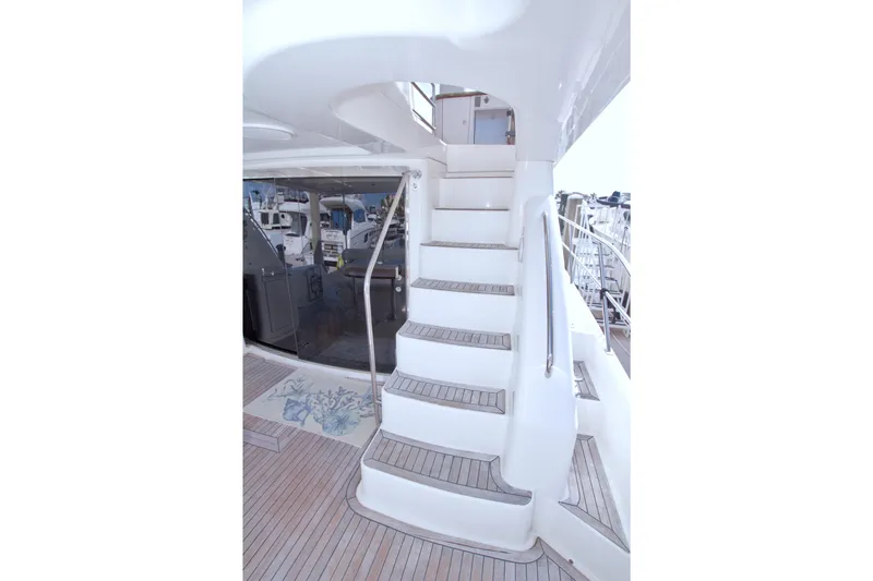Slide: The Image of Staircase on 2005 Neptunus 62 Flybridge yacht with teak flooring and sleek design. - 19