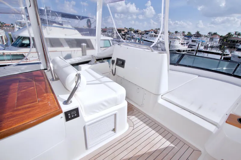 Slide: The Image of Flybridge of 2005 Neptunus 62 yacht with white seating and wooden accents. - 23