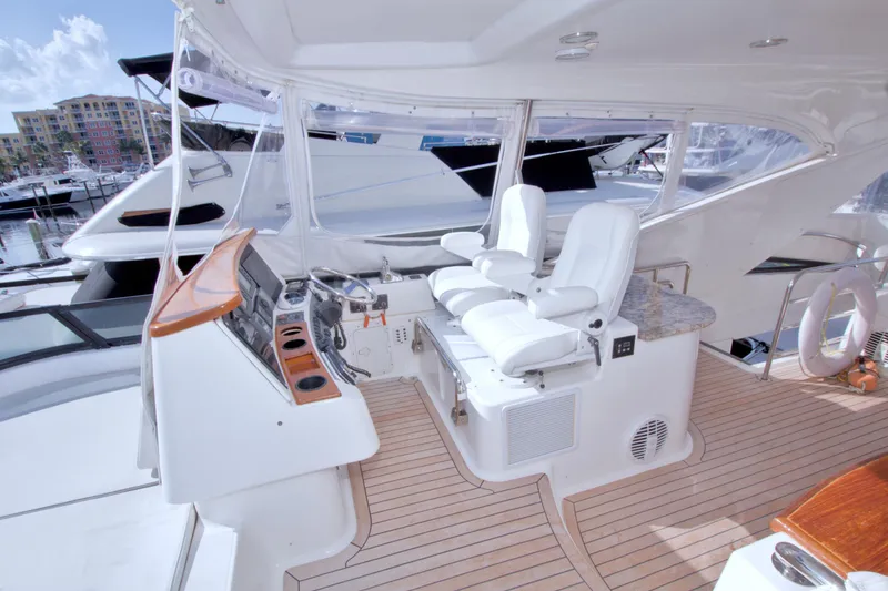 Slide: The Image of Luxurious 2005 Neptunus 62 Flybridge yacht interior with helm and seating area. - 25