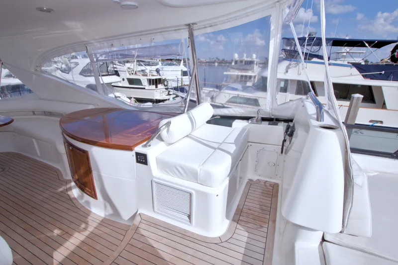 Slide: The Image of Luxurious 2005 Neptunus 62 Flybridge yacht interior with wooden and white seating. - 31
