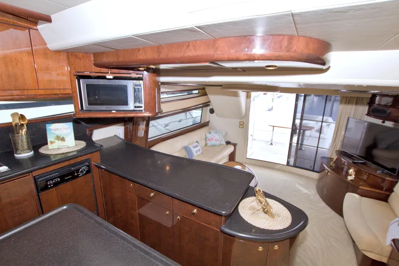 Slide: The Image of Luxurious interior of 2005 Neptunus 62 Flybridge yacht with modern kitchen and cozy seating area. - 42