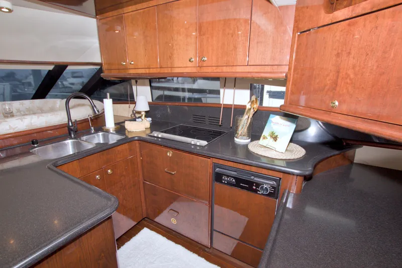 Slide: The Image of Luxurious 2005 Neptunus 62 Flybridge yacht kitchen with wood cabinetry and modern appliances. - 45