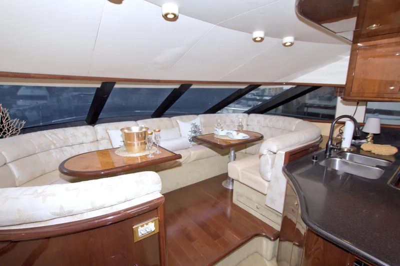 Slide: The Image of Luxurious interior of 2005 Neptunus 62 Flybridge yacht with elegant seating and dining area. - 49