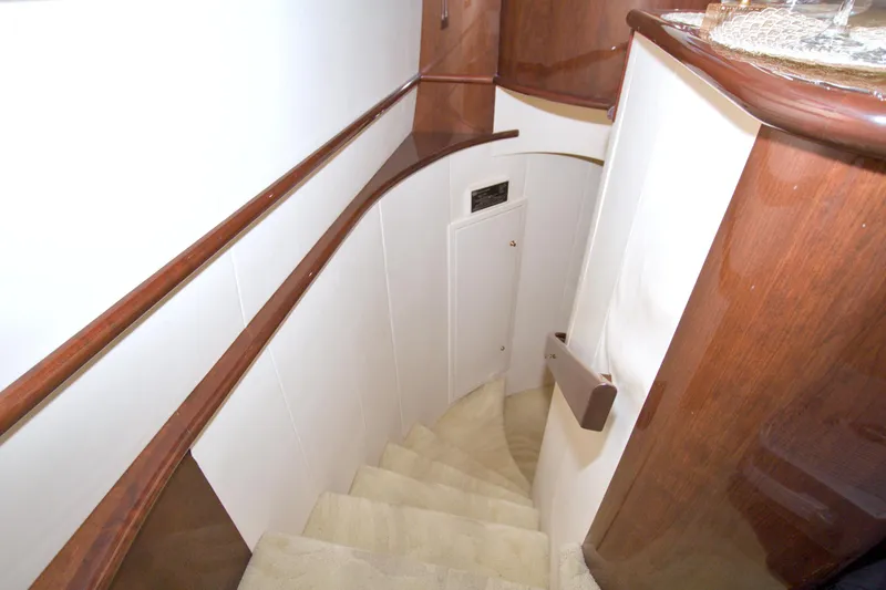 Slide: The Image of Interior staircase of 2005 Neptunus 62 Flybridge yacht with elegant wood finish. - 52