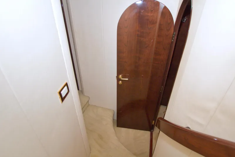 Slide: The Image of Interior of 2005 Neptunus 62 Flybridge yacht with wooden door and beige carpeted stairs. - 55