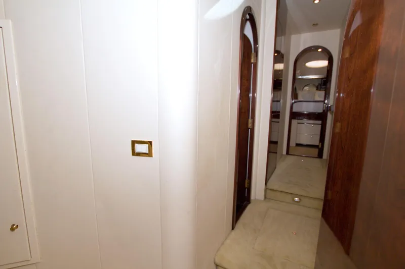 Slide: The Image of Interior hallway of 2005 Neptunus 62 Flybridge yacht with wooden doors and white walls. - 56