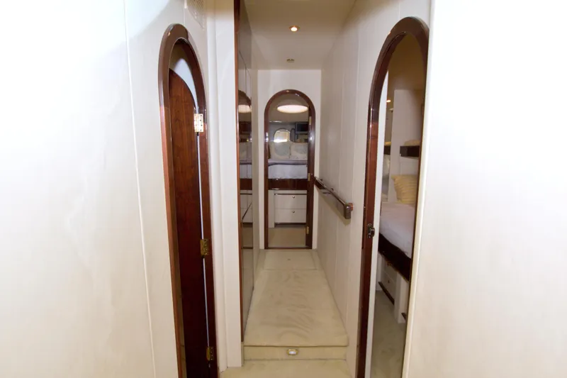Slide: The Image of Interior hallway of 2005 Neptunus 62 Flybridge yacht with wooden doors and white walls. - 57