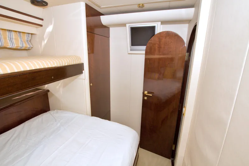 Slide: The Image of Interior cabin of 2005 Neptunus 62 Flybridge yacht with bunk beds and wooden door. - 61