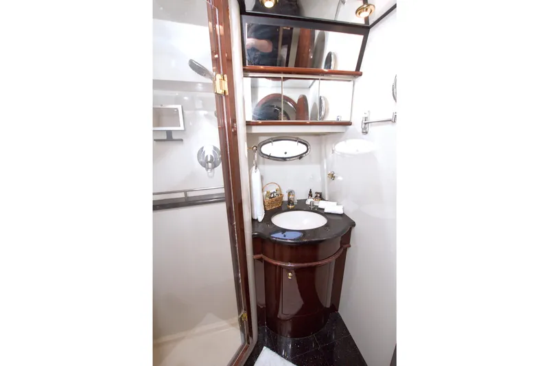 Slide: The Image of Luxurious bathroom in 2005 Neptunus 62 Flybridge yacht with elegant wood cabinetry. - 65