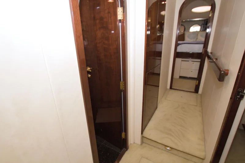 Slide: The Image of Interior hallway of 2005 Neptunus 62 Flybridge yacht with wood accents and carpeted floor. - 66