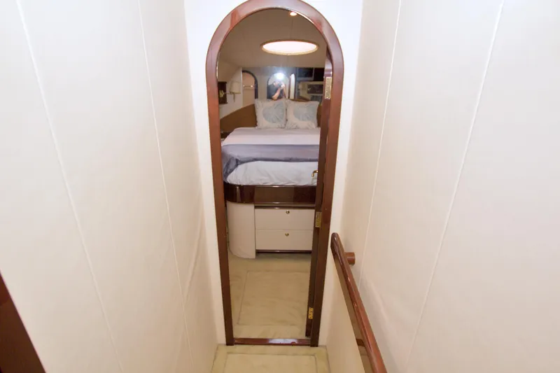 Slide: The Image of Interior view of 2005 Neptunus 62 Flybridge yacht bedroom through arched doorway. - 69