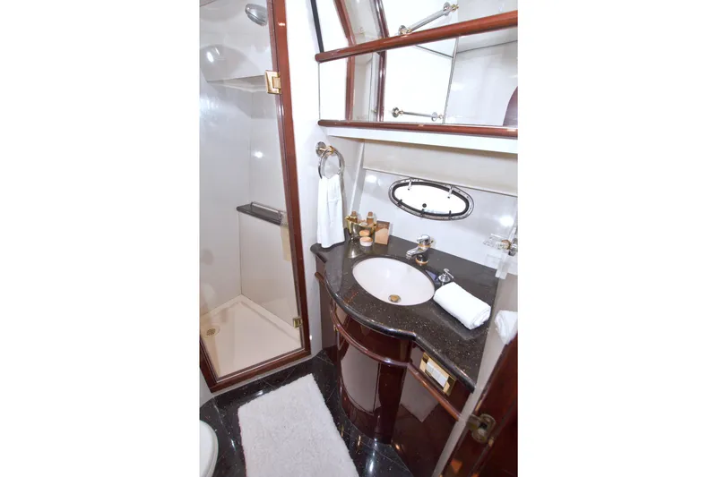 Slide: The Image of Luxurious bathroom in 2005 Neptunus 62 Flybridge yacht with elegant fixtures and shower. - 76