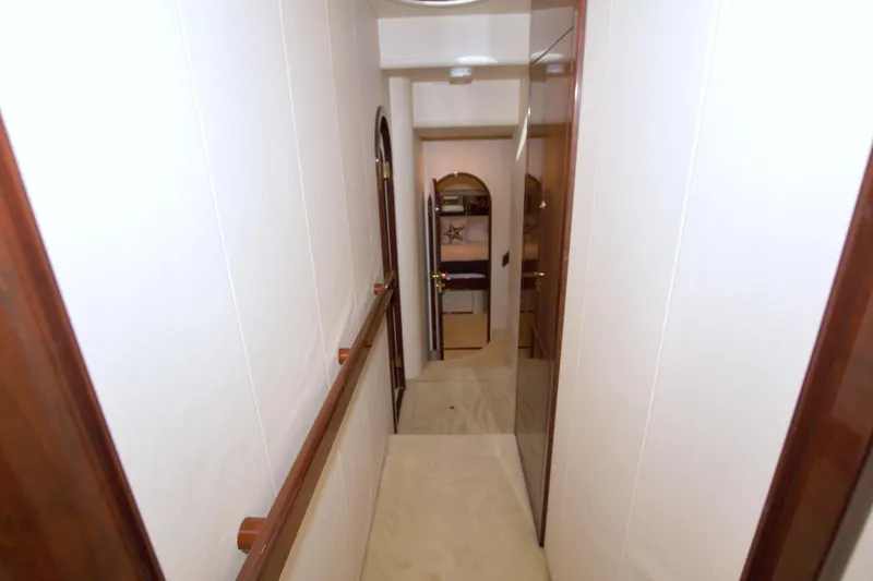 Slide: The Image of Hallway inside 2005 Neptunus 62 Flybridge yacht, featuring wooden accents and modern design. - 77